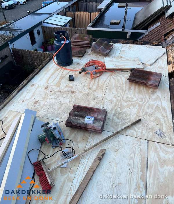 Dakreparatie werkzaamheden op plat dak met gereedschap in Beek en Donk