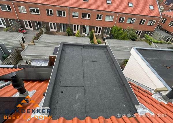 Plat dak met bitumen bedekking naast dakkapel in Beek en Donk
